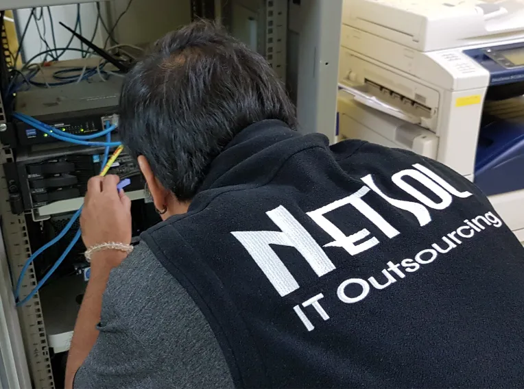 NetSol technician working on network infrastructure for a local business in Rayong, Thailand